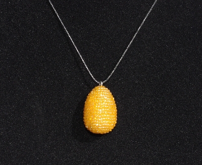 +MBA #AE3-0019  "3 Cut Orange Glass Seed Bead Egg Pendant"
