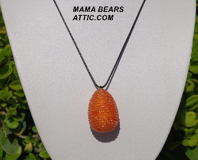 +MBA #5557-0091  "Luster Orange Glass Seed Bead Egg Pendant"