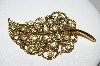 +MBA #92-010  "Vintage Goldtone Light Green Rhinestone Leaf Brooch"