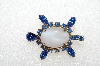 **MBA #E56-014   "Vintage Gold Tone Fancy White Glass & Blue Crystal Rhinestone Turtle Pin"