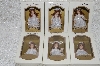 +MBA #SG9-029  "2004 Set Of 6 White With Lace Trim Red Headed Collectible Porcelain Doll Ornaments"